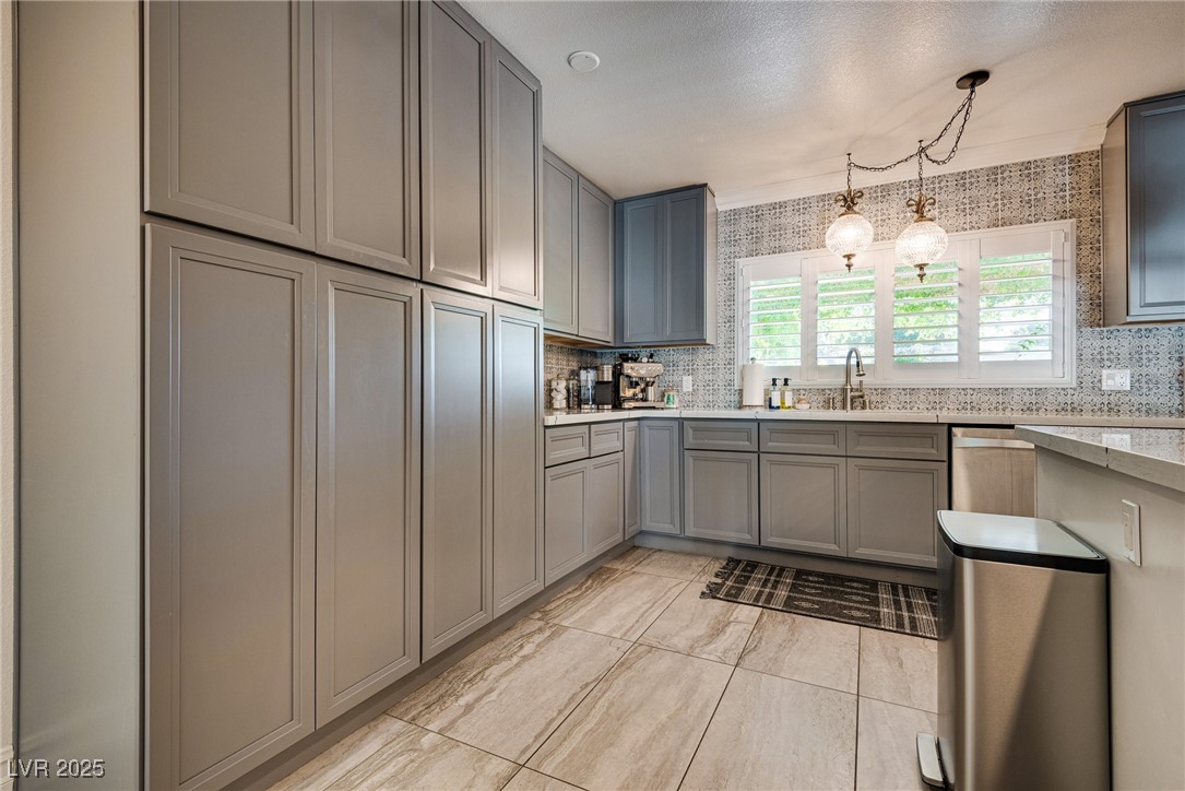 1321 South 7th Street Las Vegas, NV 89104 - Photo 15 of 47 Kitchen featuring gray cabinetry, tasteful backspl