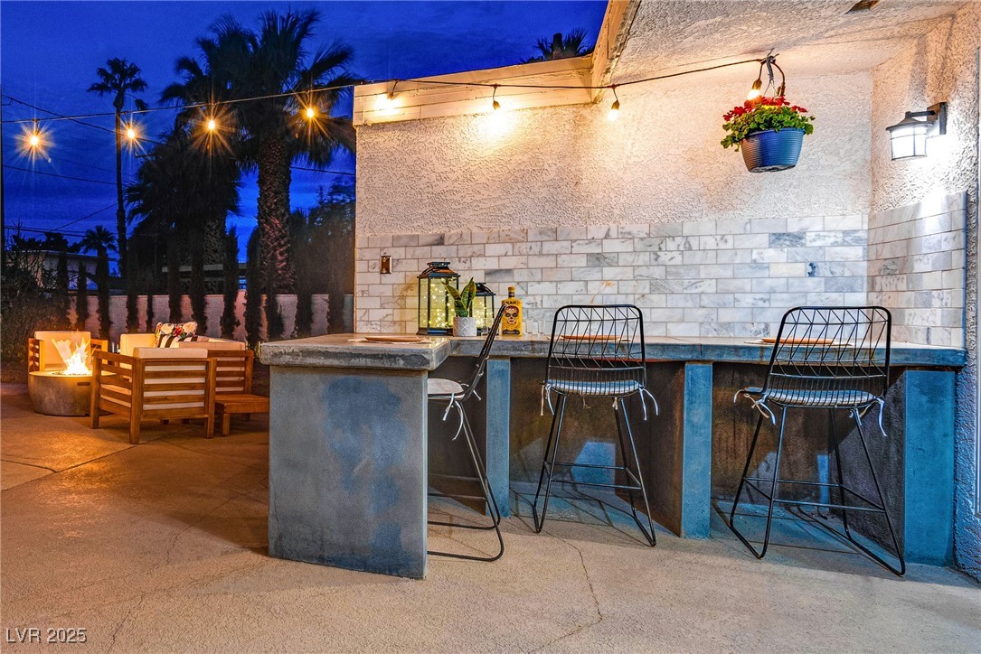 1321 South 7th Street Las Vegas, NV 89104 - Photo 4 of 47 Patio at night with an outdoor fire pit and a pati