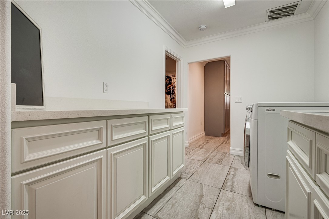 1321 South 7th Street Las Vegas, NV 89104 - Photo 41 of 47 Laundry area with cabinet space, ornamental moldin