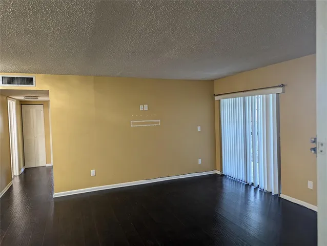 an empty room with wooden floor