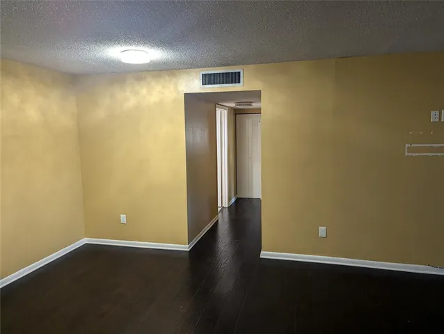 an empty room with wooden floor