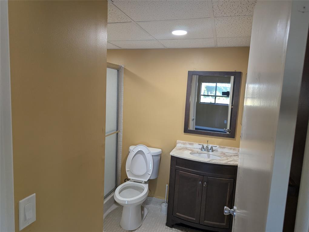 9612 West McNab Road, Unit 104 Tamarac, FL 33321 - Photo 8 of 8 a bathroom with a toilet sink and mirror