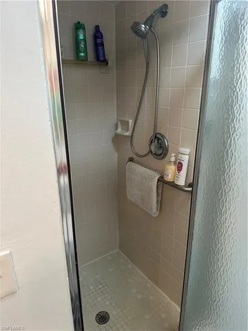 a bathroom with a granite countertop sink and a washing machine