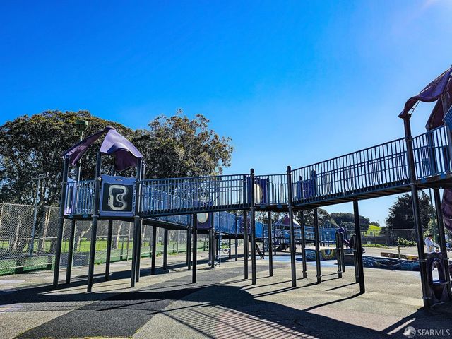 a view of a street with a cars parked in front of it
