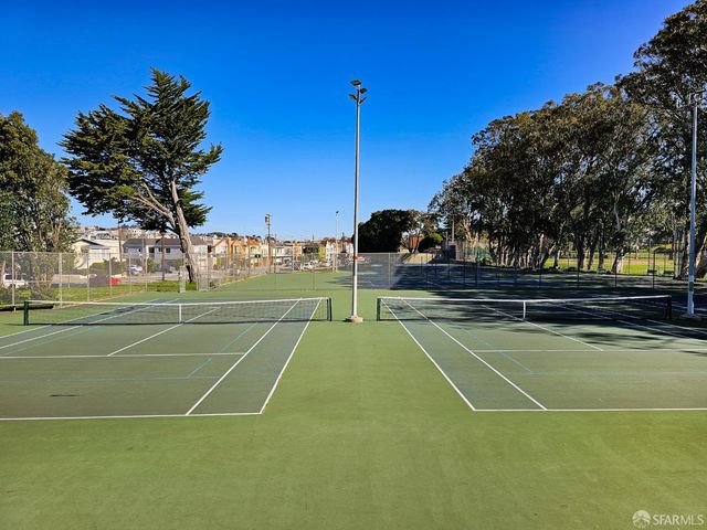 a view of a roof deck with table and chairs