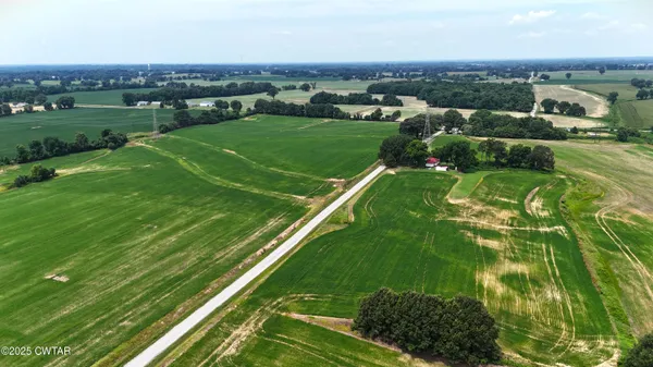 an aerial view of huge green field with lots of green space