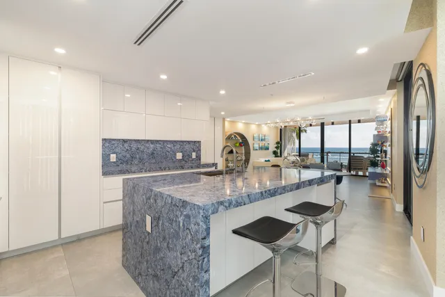 a large kitchen with a table and chairs