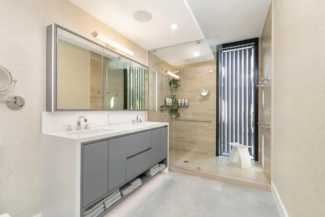a bathroom with a double vanity sink mirror and bathtub
