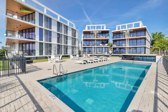 a living room with lots of books and a dining table