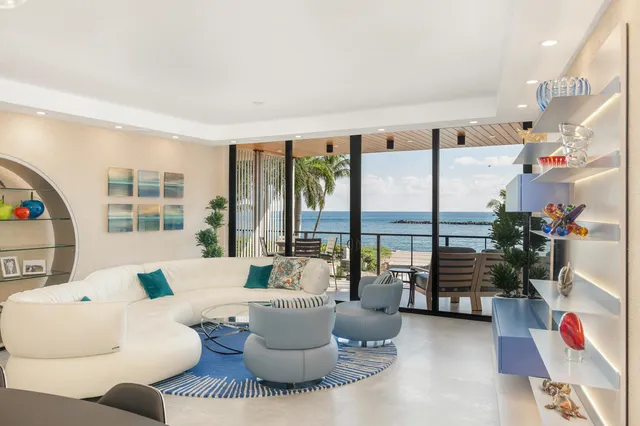 a living room with furniture and a floor to ceiling window