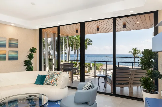 a living room with furniture and a floor to ceiling window