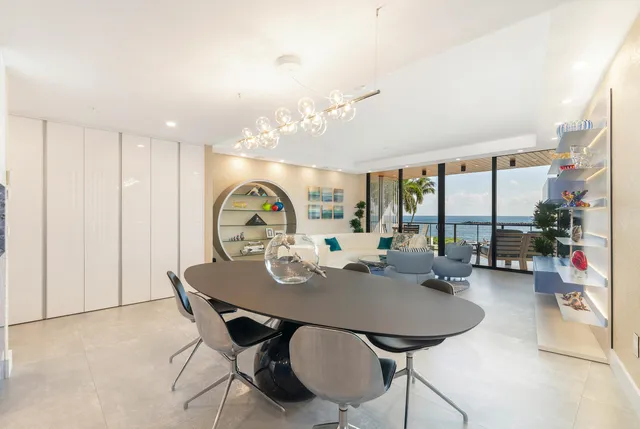 a view of a dining room with furniture large windows and wooden floor