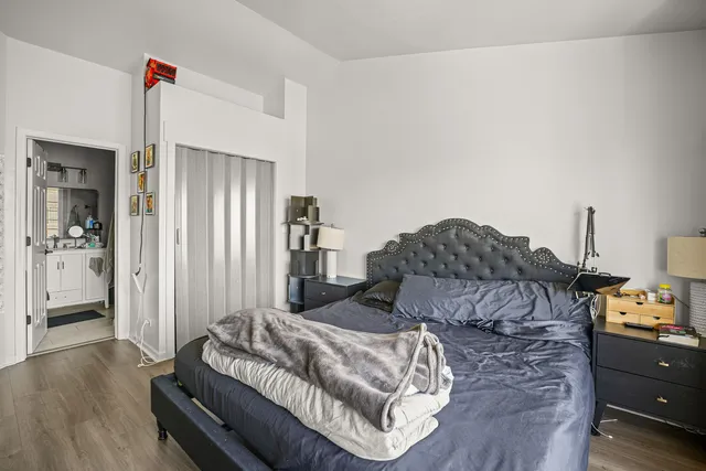 a living room with furniture a bed and a dresser