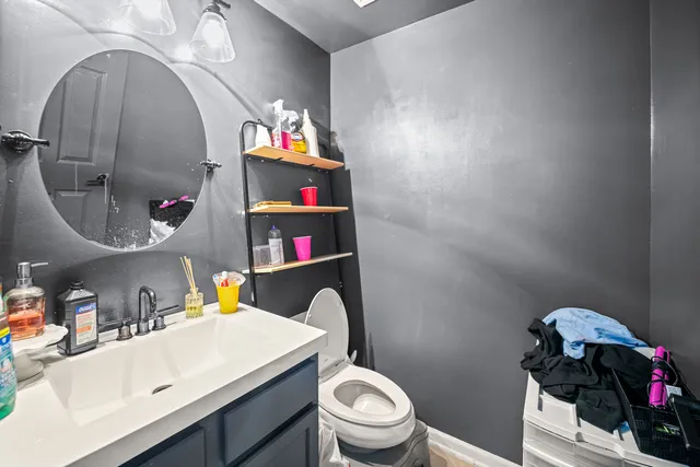 a bathroom with a sink toilet and a mirror