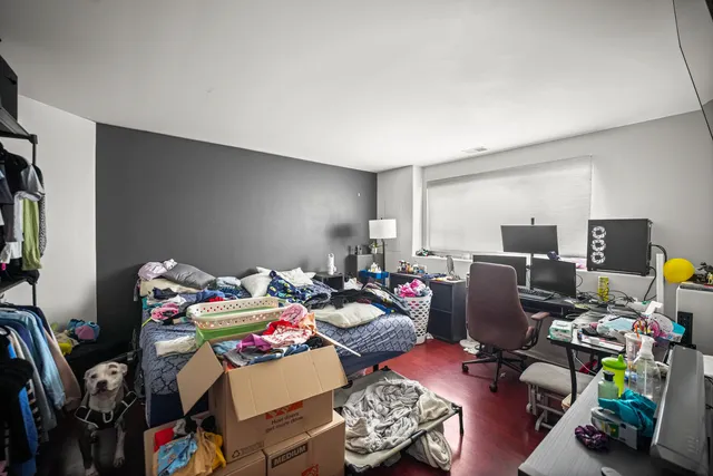 a bedroom with furniture and a workspace