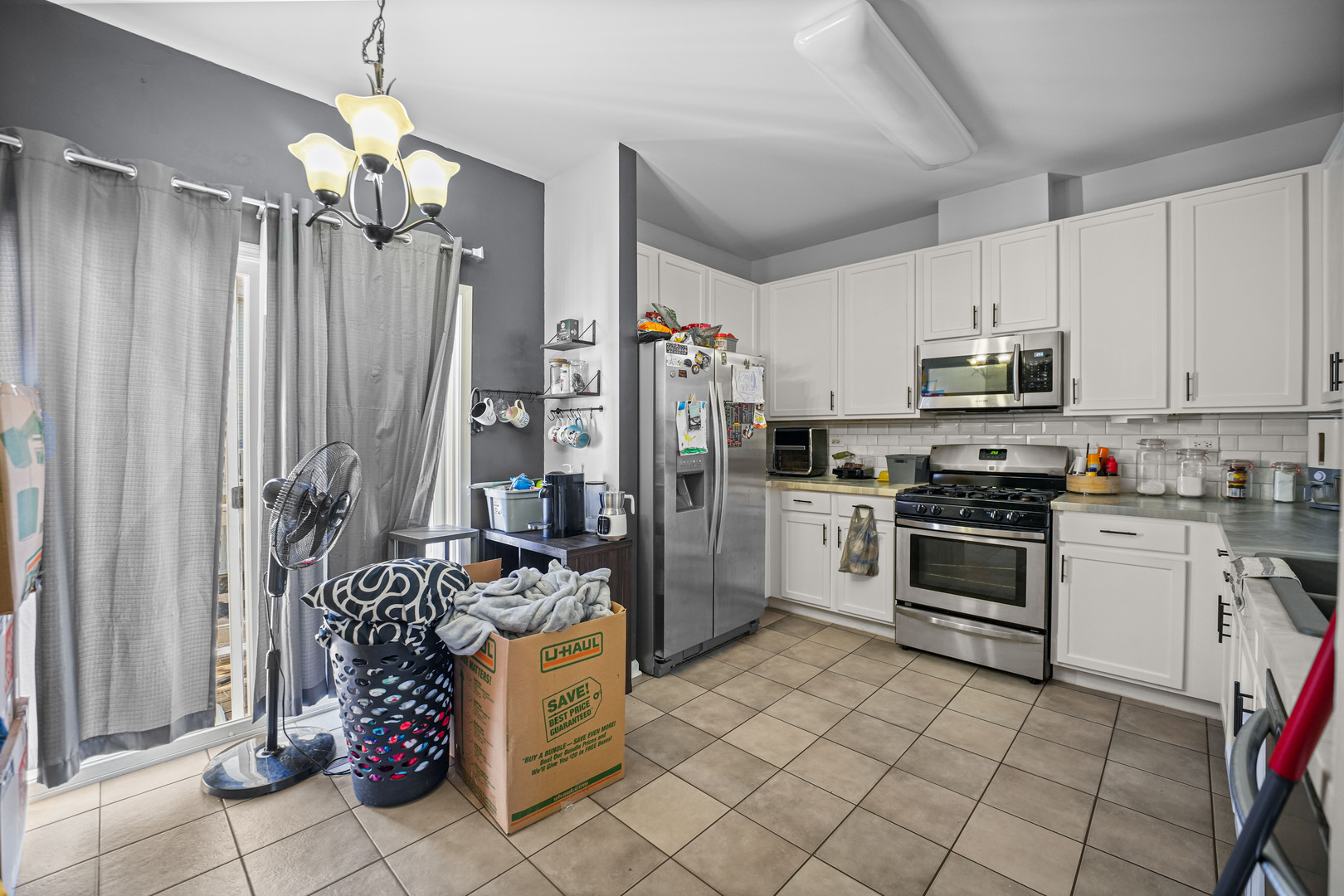602 South Rosehall Lane Round Lake, IL 60073 - Photo 7 of 19 a kitchen with a stove a sink and a refrigerator