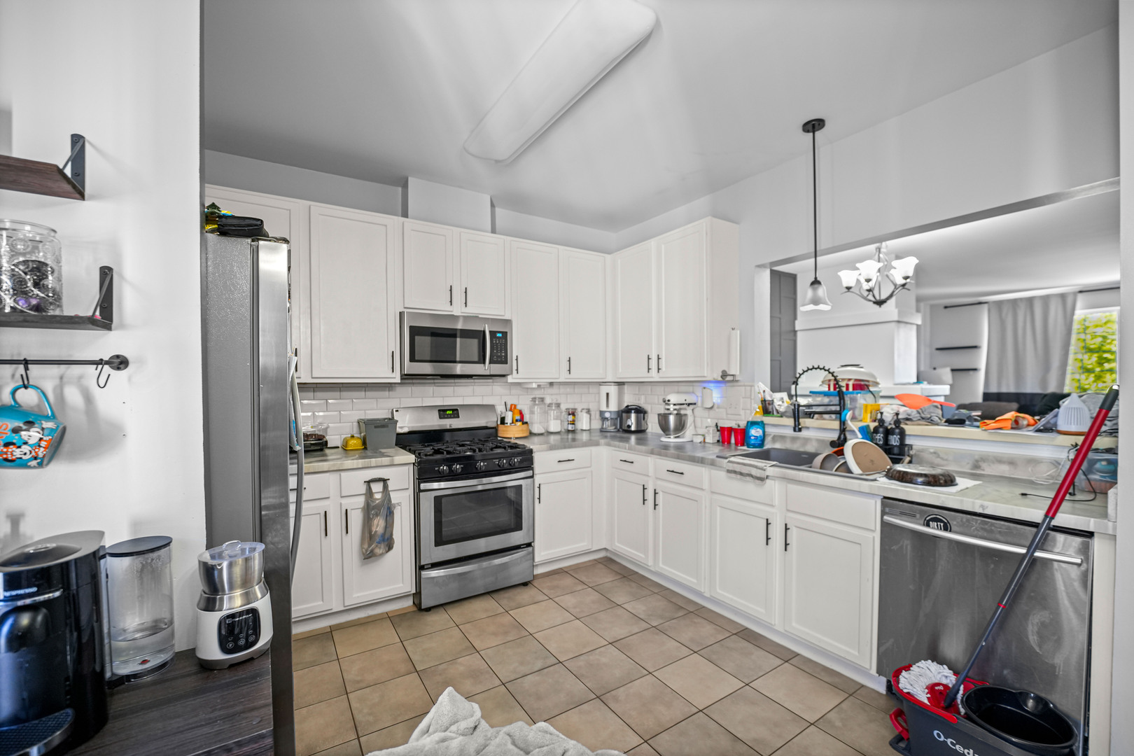 602 South Rosehall Lane Round Lake, IL 60073 - Photo 8 of 19 a kitchen with a sink stainless steel appliances and white cabinets