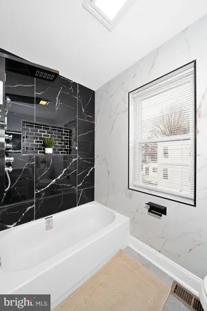 a bathroom with a bathtub and a shower