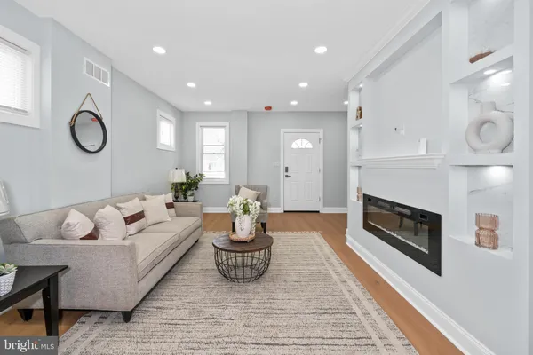 a living room with furniture and a fireplace