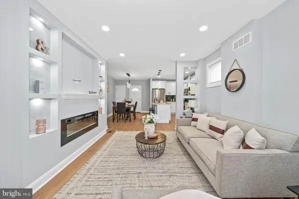 a living room with furniture kitchen and a fireplace