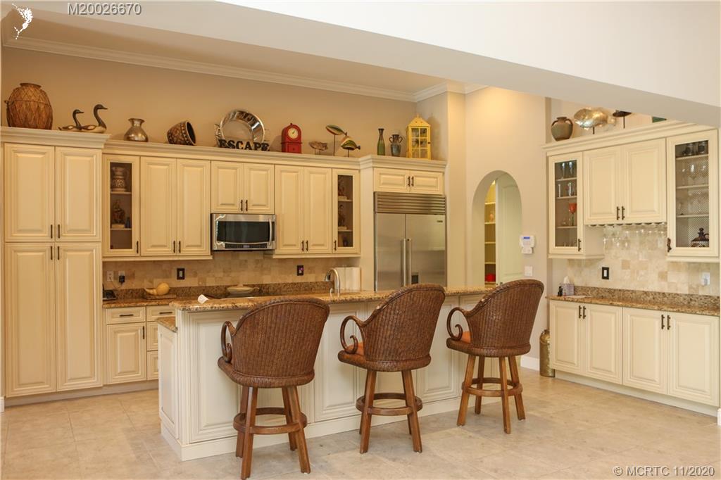 4961 Southeast Inlet Isle Way Stuart, FL 34997 - Photo 2 of 37 a living room with stainless steel appliances granite countertop furniture and a window