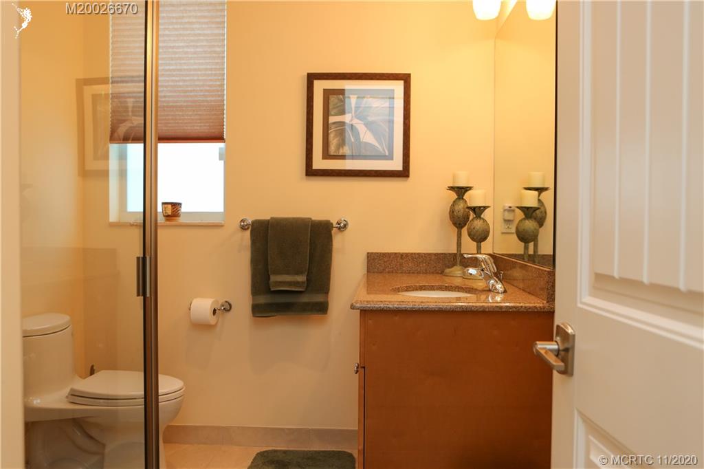 4961 Southeast Inlet Isle Way Stuart, FL 34997 - Photo 29 of 37 a bathroom with a sink a toilet and shower