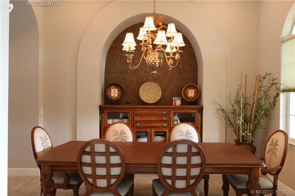 4961 Southeast Inlet Isle Way Stuart, FL 34997 - Photo 9 of 37 a view of a table and chairs in the patio