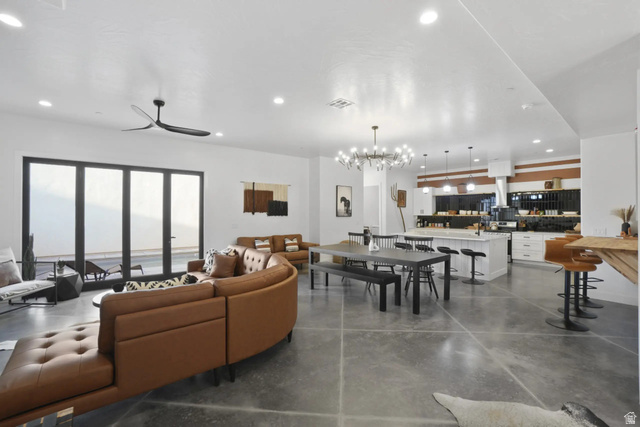 4346 Canterbury Road Hurricane, UT 84737 - Photo 6 of 37 Living room with concrete flooring, hanging lights, and a ceiling fan