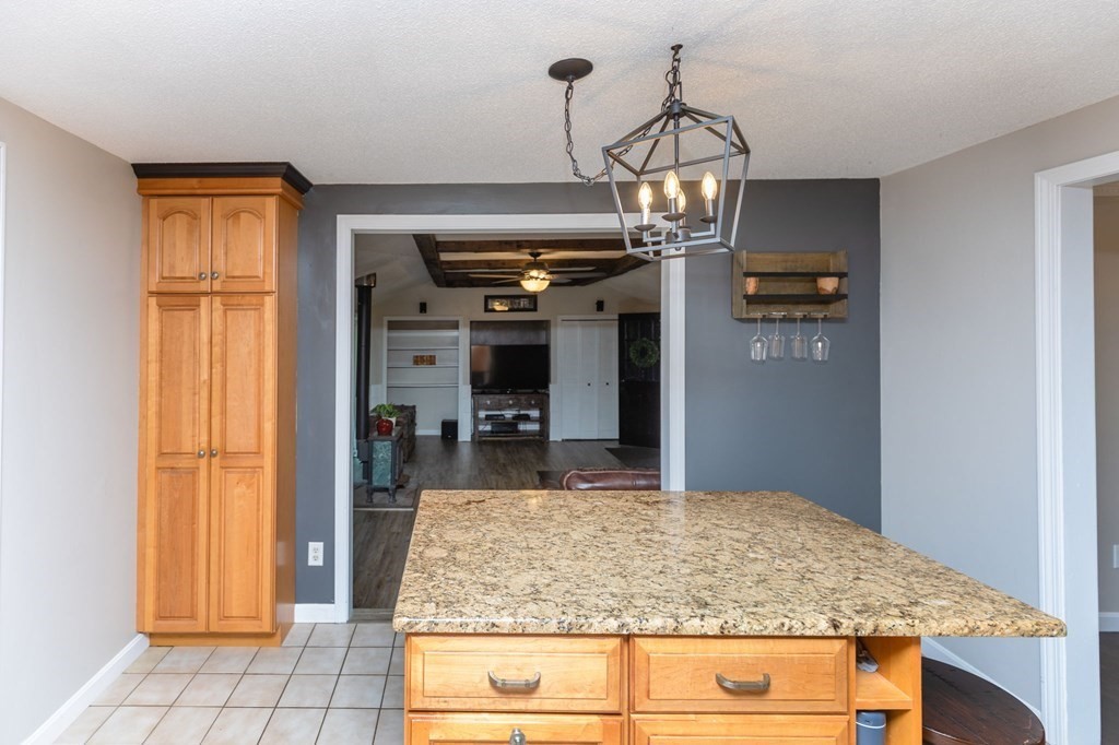 236 High Street Rochester, MA 02770 - Photo 9 of 35 a room with kitchen island granite countertop wooden floor and chandelier