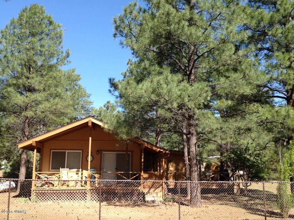 2846 Timber Trail Loop Overgaard, AZ 85933 - Photo 1 of 16 a front view of a house with garden