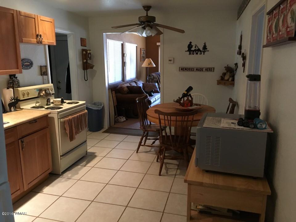2846 Timber Trail Loop Overgaard, AZ 85933 - Photo 11 of 16 a kitchen with stainless steel appliances a stove a sink and a refrigerator