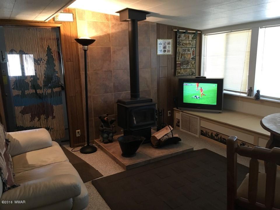 2846 Timber Trail Loop Overgaard, AZ 85933 - Photo 12 of 16 a living room with furniture and a flat screen tv