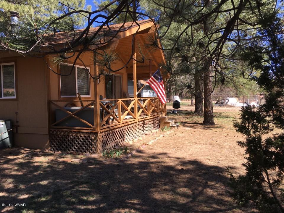 2846 Timber Trail Loop Overgaard, AZ 85933 - Photo 2 of 16 a view of a yard with wooden fence