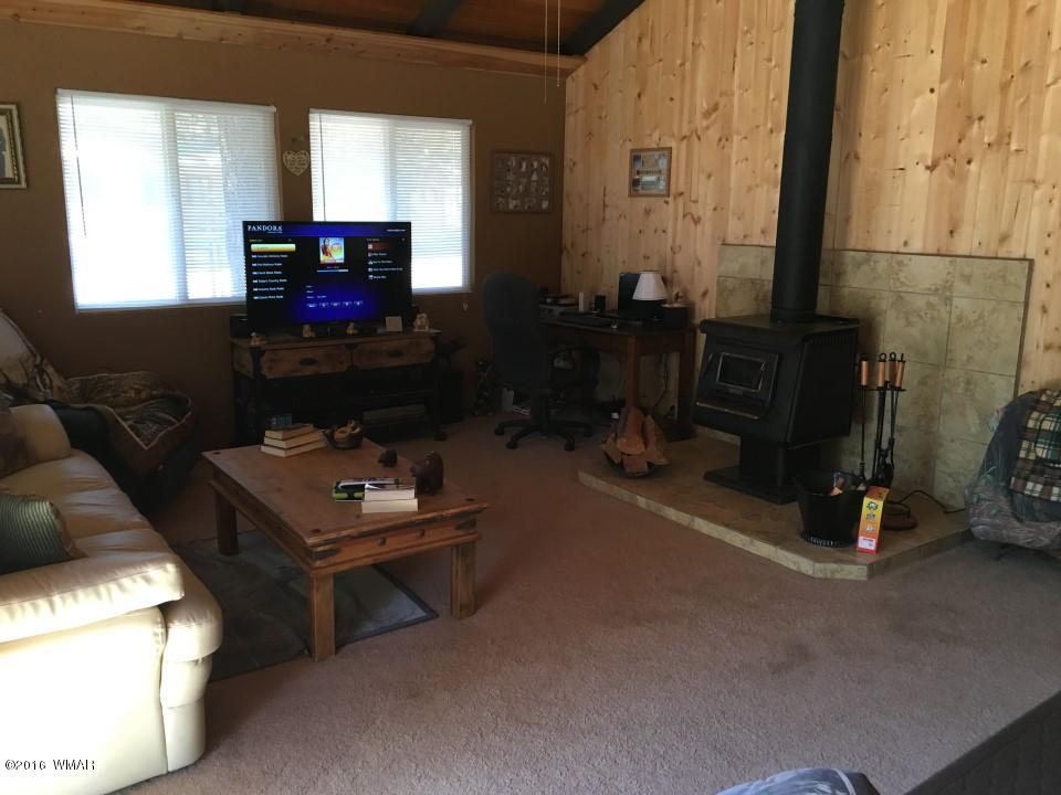 2846 Timber Trail Loop Overgaard, AZ 85933 - Photo 4 of 16 a living room with furniture and a flat screen tv