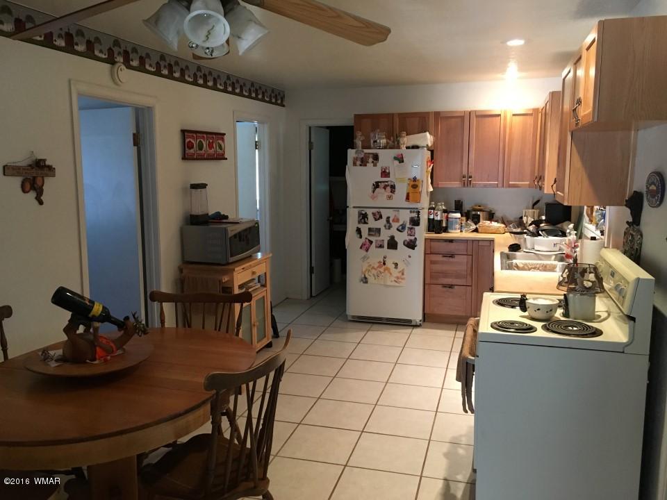2846 Timber Trail Loop Overgaard, AZ 85933 - Photo 7 of 16 a kitchen with refrigerator and cabinets