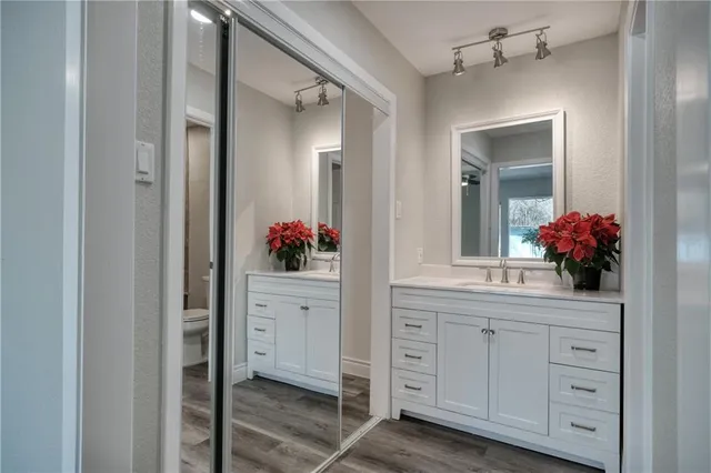 a view of a room with wooden floor and a bathroom