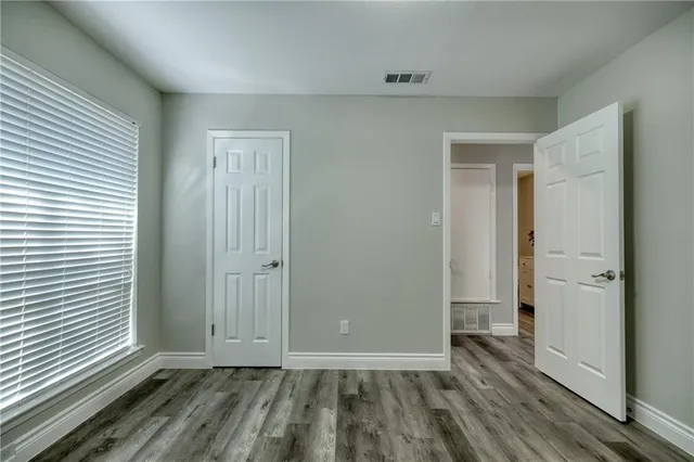 a bathroom with a granite countertop sink toilet and a mirror