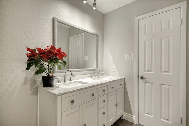 a front view of a house with a garden and trees