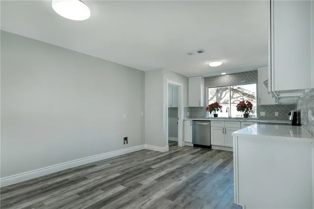 a kitchen with a sink cabinets and window