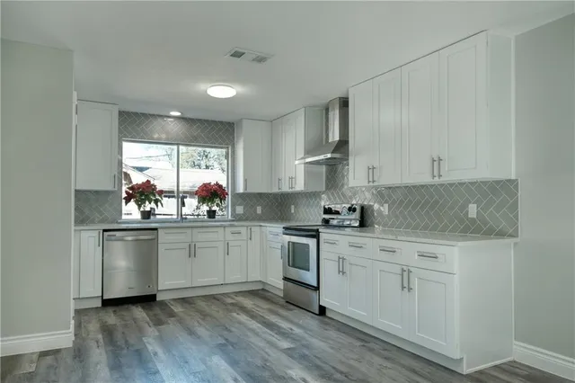 a kitchen with a sink stove and cabinets