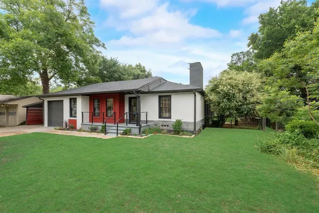 a front view of a house with a garden and porch