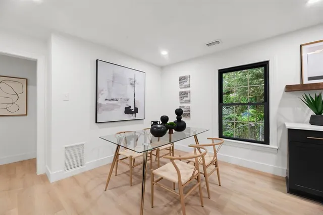 a kitchen with a sink a stove a dining table and chairs