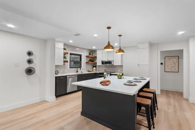a view of a dining room with furniture wooden floor and a chandelier