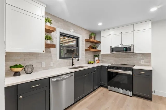 a kitchen with stainless steel appliances a cabinets and a counter top space