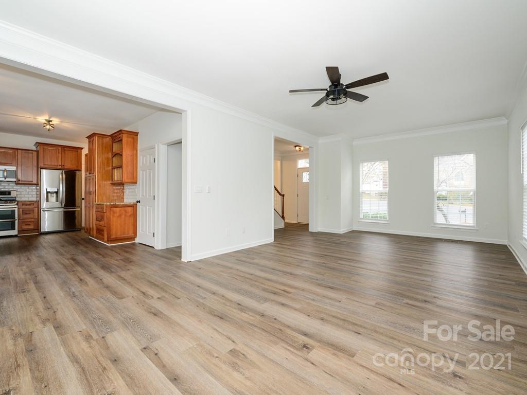 1446 Autumn Ridge Lane Fort Mill, SC 29708 - Photo 14 of 35 an empty room with wooden floor a ceiling fan and windows