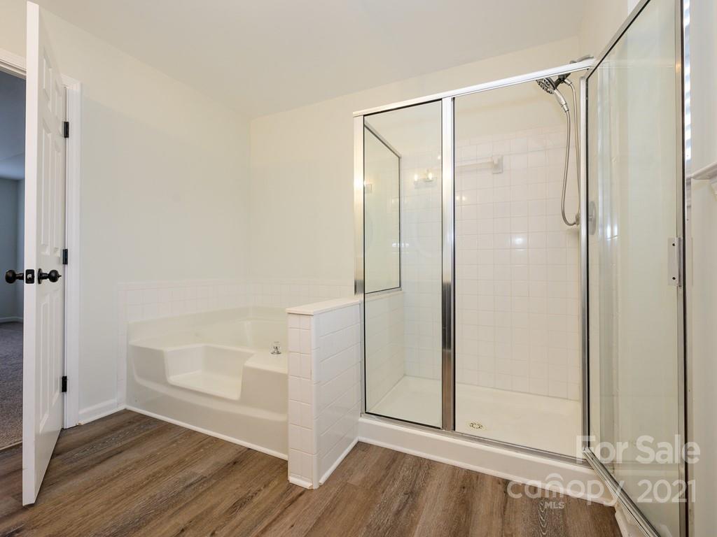 1446 Autumn Ridge Lane Fort Mill, SC 29708 - Photo 22 of 35 a bathroom with a glass shower door