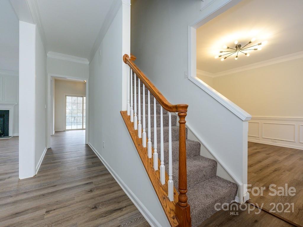 1446 Autumn Ridge Lane Fort Mill, SC 29708 - Photo 4 of 35 a view of a hallway with wooden floor and staircase