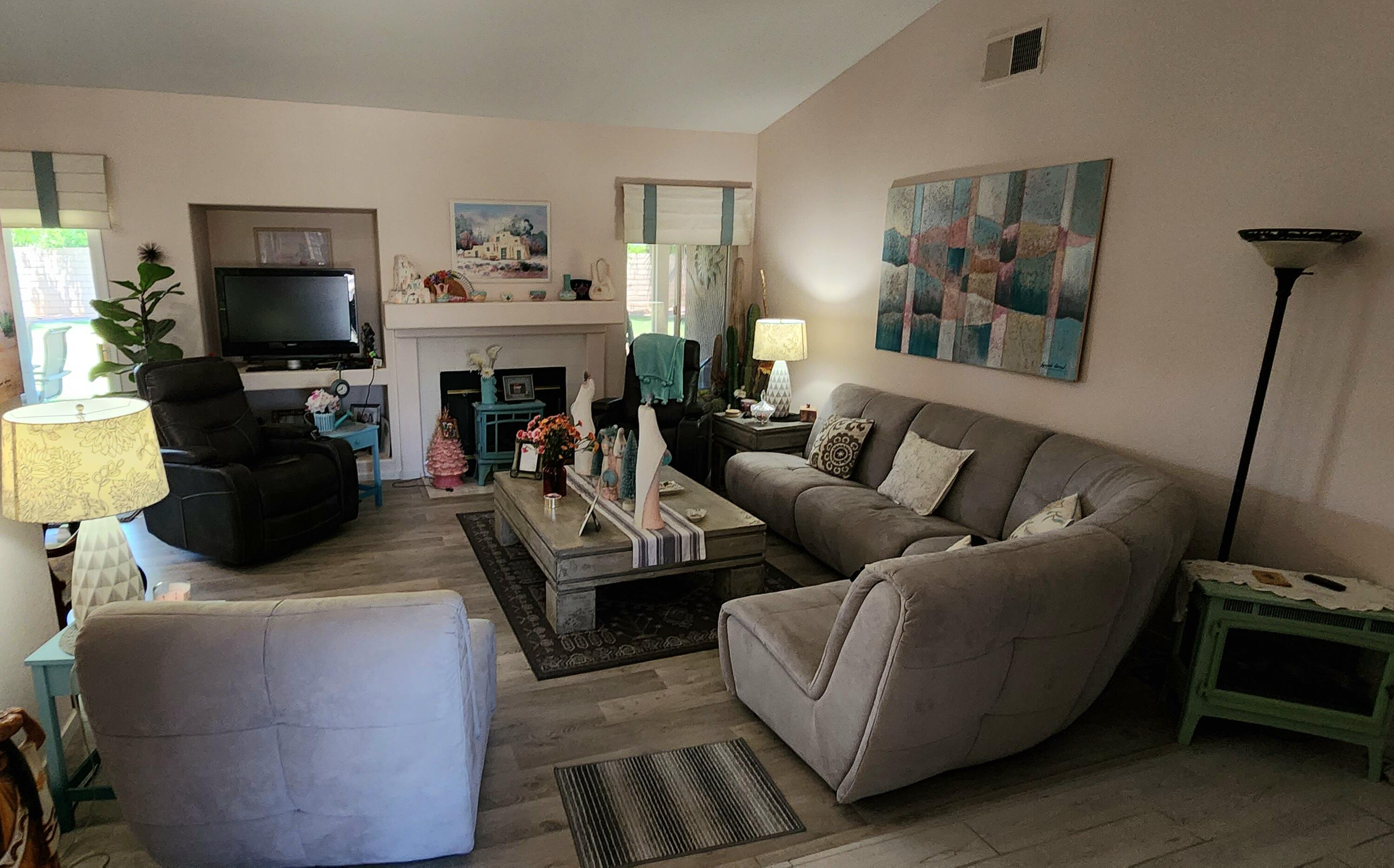 78820 Irwin Circle La Quinta, CA 92253 - Photo 9 of 12 a living room with furniture a flat screen tv and a fireplace