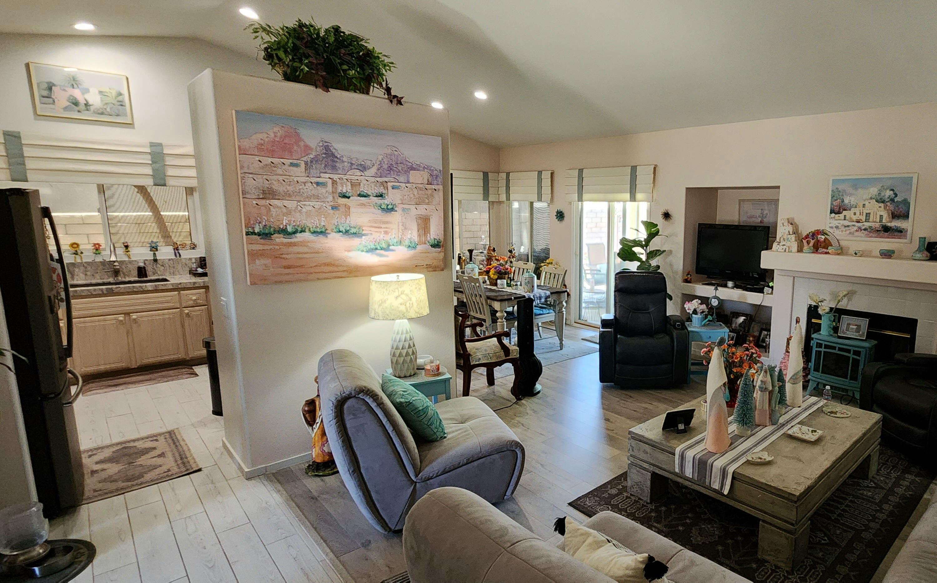 78820 Irwin Circle La Quinta, CA 92253 - Photo 12 of 12 a living room with furniture a flat screen tv and a fireplace