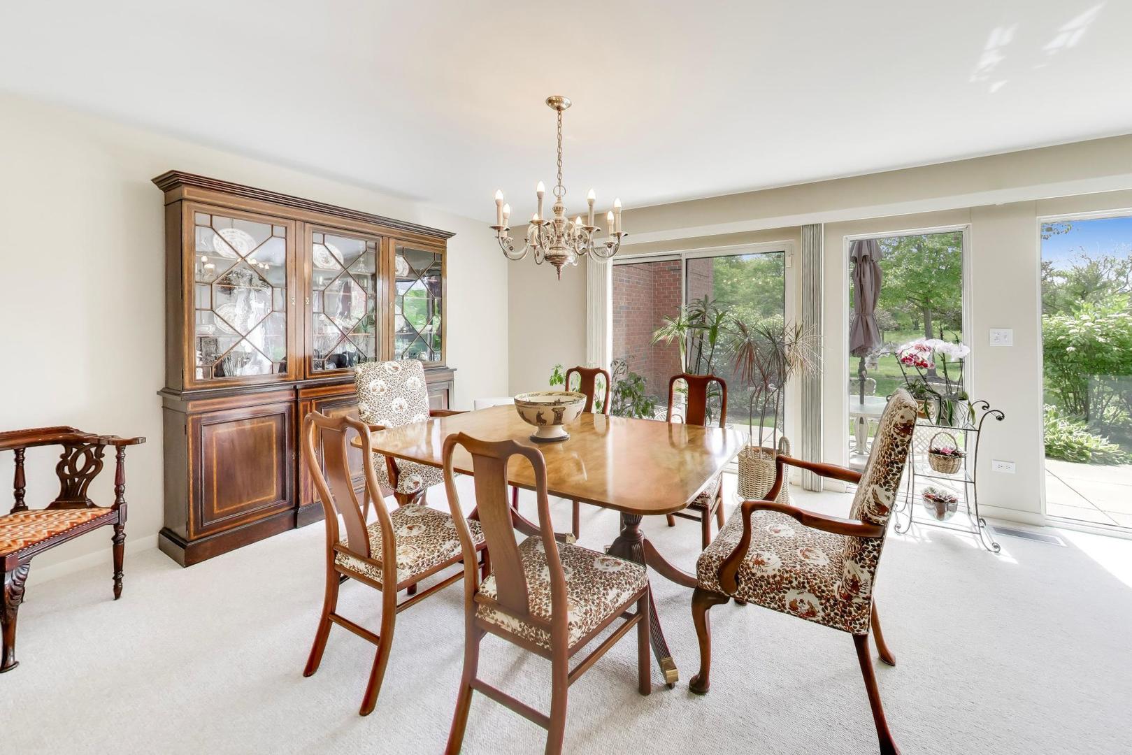 495 Milford Road Deerfield, IL 60015 - Photo 6 of 33 a view of a dining room with furniture large windows and wooden floor